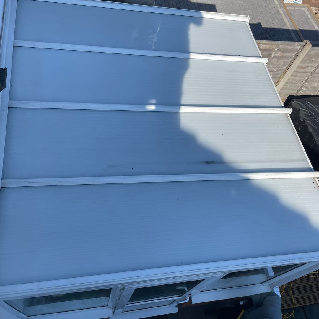 Freshly cleaned conservatory roof with clear panels and restored appearance.